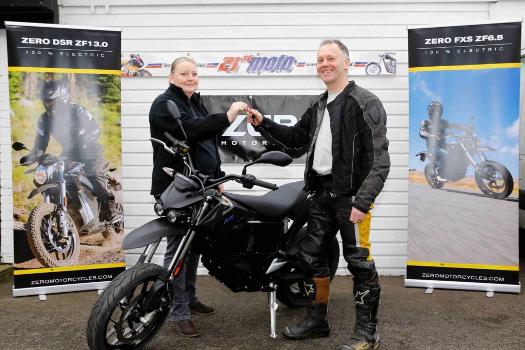 Fred Murphy collecting the UK's first electric bike to be sold with an OLEV 'plug in...