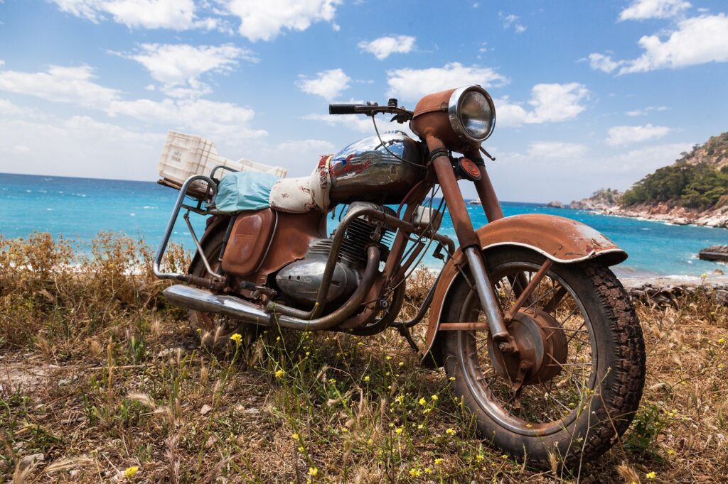 Rusty chrome motorcycle with sea in the background
