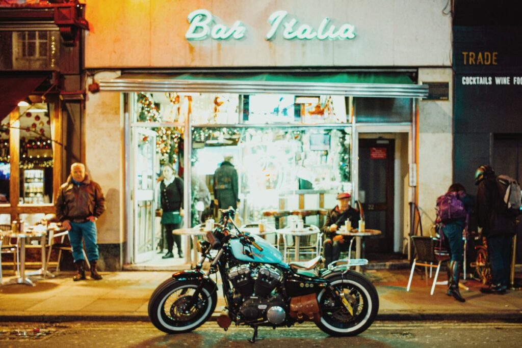 Motorbike parked outside Bar Italia in Soho, London